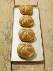 Four fresh bread rolls — Stock Photo