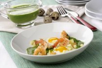 Creamed spinach and apple shrimp on white plate — Stock Photo