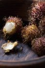 Rambutans in wooden bowl — Stock Photo