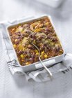 Chili con carne bake in white dish over towel — Stock Photo
