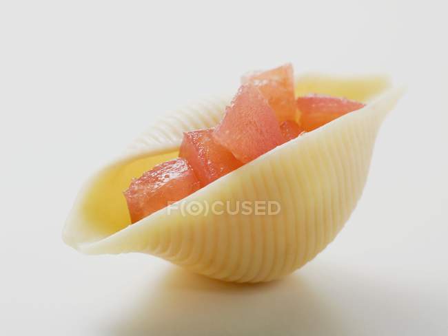 Pasta shell filled with diced tomato — Stock Photo
