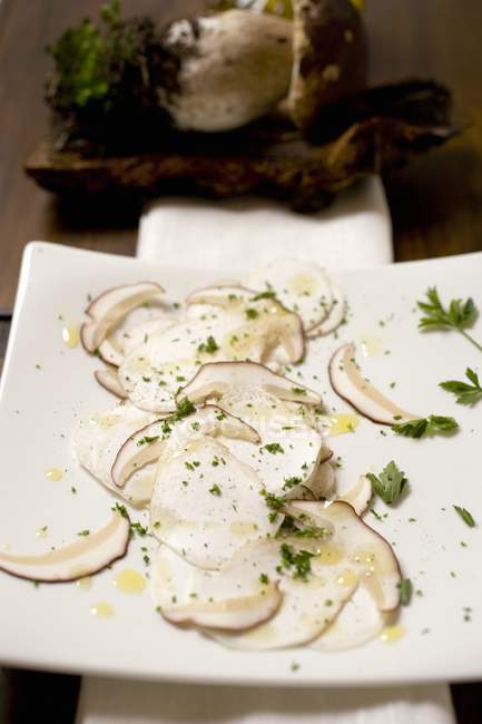 Closeup view of Cep mushroom Carpaccio on chopping board — Stock Photo