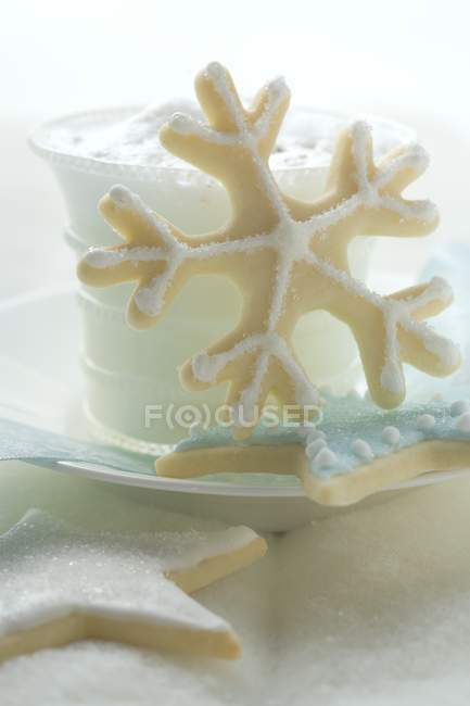 Glass of milk foam on plate — Stock Photo