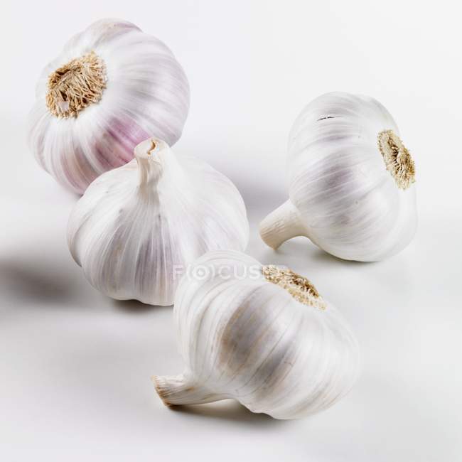 Four garlic bulbs — Stock Photo