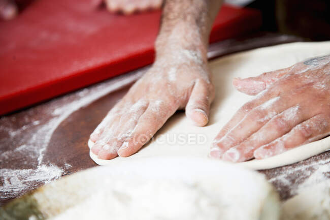 Close-up shot of delicious Flatten and shape pizza dough — Stock Photo