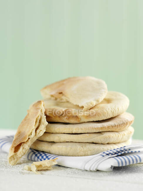 Stack of pancakes with fresh fruits on a blue background — Stock Photo