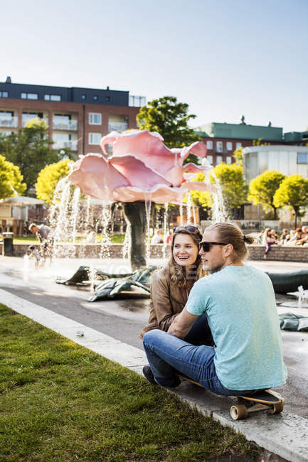 Happy woman sitting with man — Stock Photo