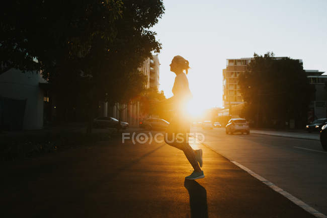Woman starting running on urban street — Stock Photo