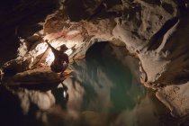 Filipino tour guide holding lantern inside Sumaging Cave or Big Cave near Sagada, Luzon, Philippines — Stock Photo