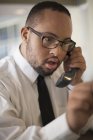 African American man with Down Syndrome as a waiter taking reservations in restaurant — Stock Photo