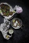 Broccoli cheese fritters and tahini sauce on black surface — Stock Photo