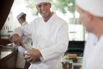 Chefs cooking in restaurant kitchen — Stock Photo