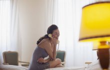 Smiling woman talking on telephone — Stock Photo