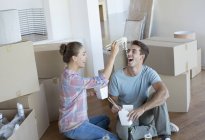 Couple eating Chinese take out food in new house — Stock Photo