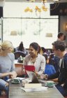 Creative business people meeting, using digital tablet and laptop in cafe — Stock Photo