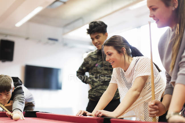 Teenagers playing pool in community center — Stock Photo