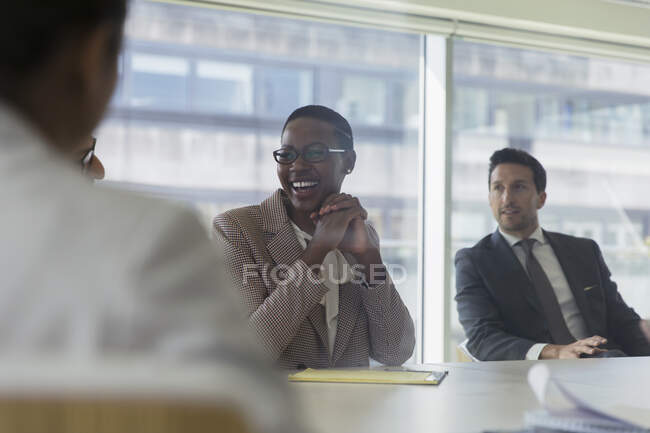 Laughing businesswoman in conference room meeting — Stock Photo