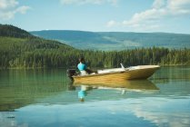 Man travelling on motorboat in a lake — Stock Photo