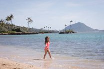 Girl walking on water in the beach on a sunny day — Stock Photo