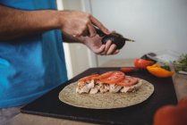 Close-up of male hands cutting avocado in kitchen at home — Stock Photo
