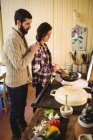 Couple preparing food together in kitchen at home — Stock Photo