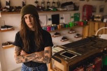 Portrait of beautiful woman standing in workshop — Stock Photo