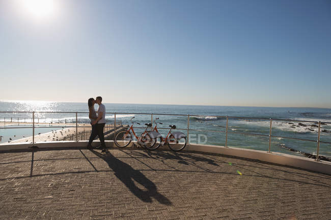 Romantic couple kissing on promenade near beach — Stock Photo