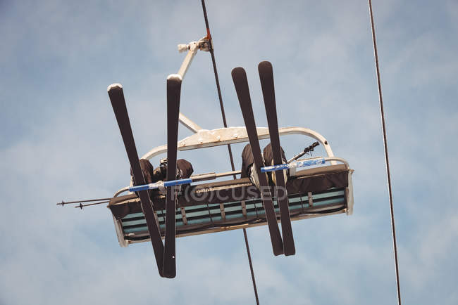 Low angle view of skiers travelling in ski lift at ski resort — Stock Photo