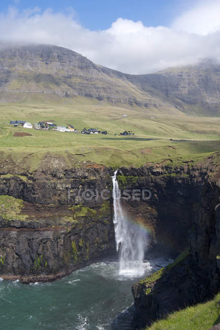 The Mulafossur waterfall near Gasadalur, one of the landmarks of Faroe Islands. The island Vagar, part of the Faroe Islands in the North Atlantic. Faroe Islands, Denmark, Europe — Stock Photo