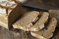Freshly baked bread on chopping board. — Stock Photo