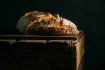 Rustic bread on dark — Stock Photo