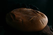 Rustic bread on dark — Stock Photo