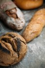 Rustic bread on dark — Stock Photo