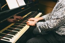 Crop male hands playing piano keys — Stock Photo