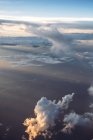 Aerial view to clouds and ground in sunset lights. — Stock Photo