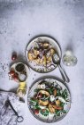 From above plates with gourmet salads made of peaches, red onion, cheese, oil and black pepper on table — Stock Photo