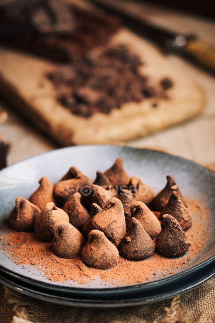 Still life of chocolate truffles in a rustic plate — Stock Photo