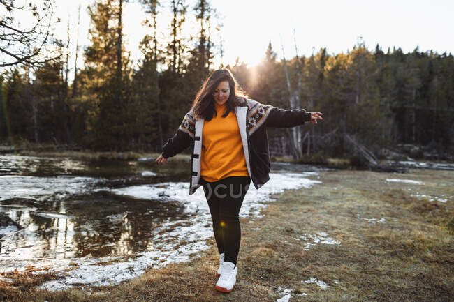 Cheerful young woman on pond in forest — Stock Photo