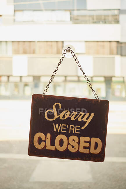 Close sign at small business window with blurred background — Stock Photo