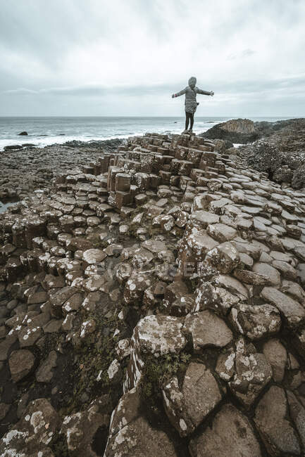 Female standing on cliff and contemplating — Stock Photo