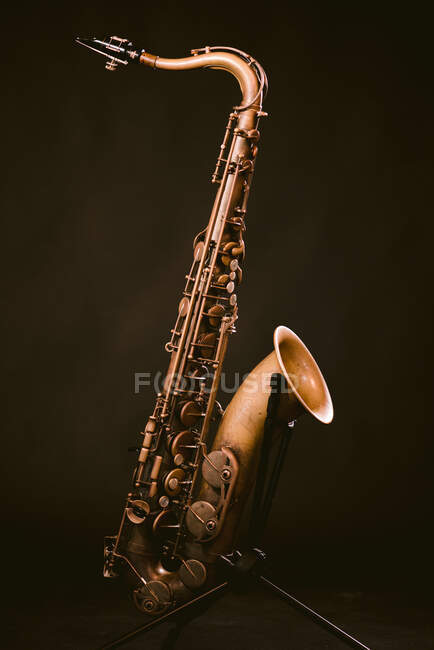 Contemporary classic brass wind instrument saxophone isolated on black background in musical studio — Fotografia de Stock