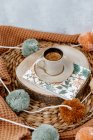 White and brown cup with tea balls on a wooden background — Stock Photo
